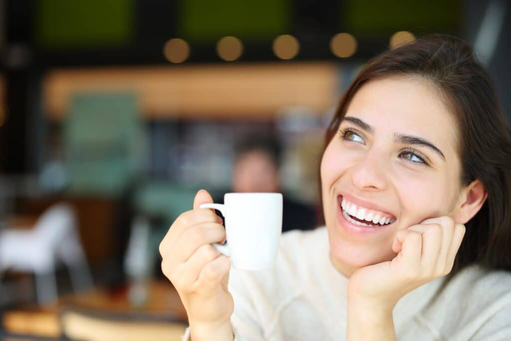 happy woman smiling in a cafe, perfect white teeth