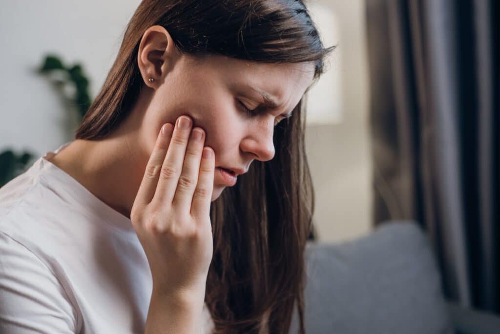 closeup of a young woman with jaw pain